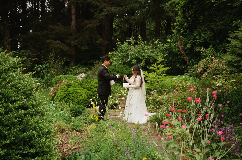 Bride and groom exchanging vows in a lush garden