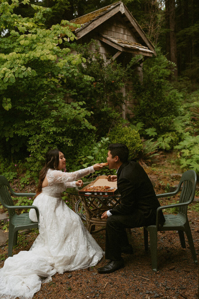 Bride feeding groom a bite of pizza