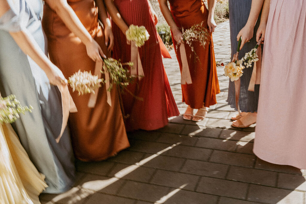 Bridesmaids holding flowers, earthy color palette wedding