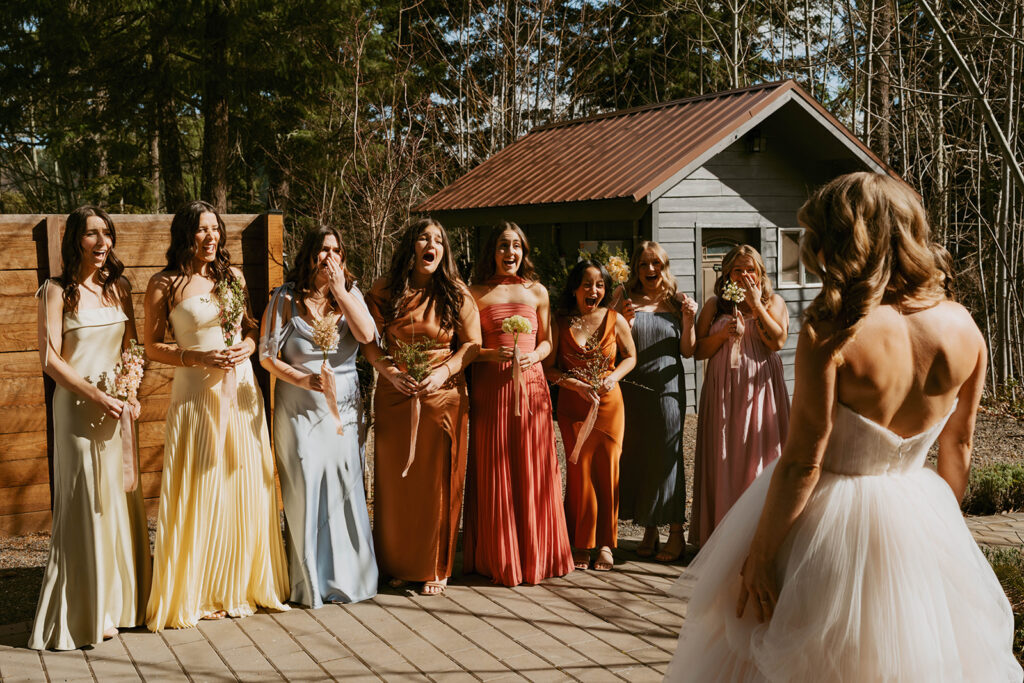 Bridesmaids’ first look reaction, outdoor wedding venue Washington state