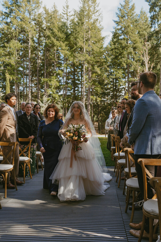 Bride walking down aisle in forest wedding venue Washington state