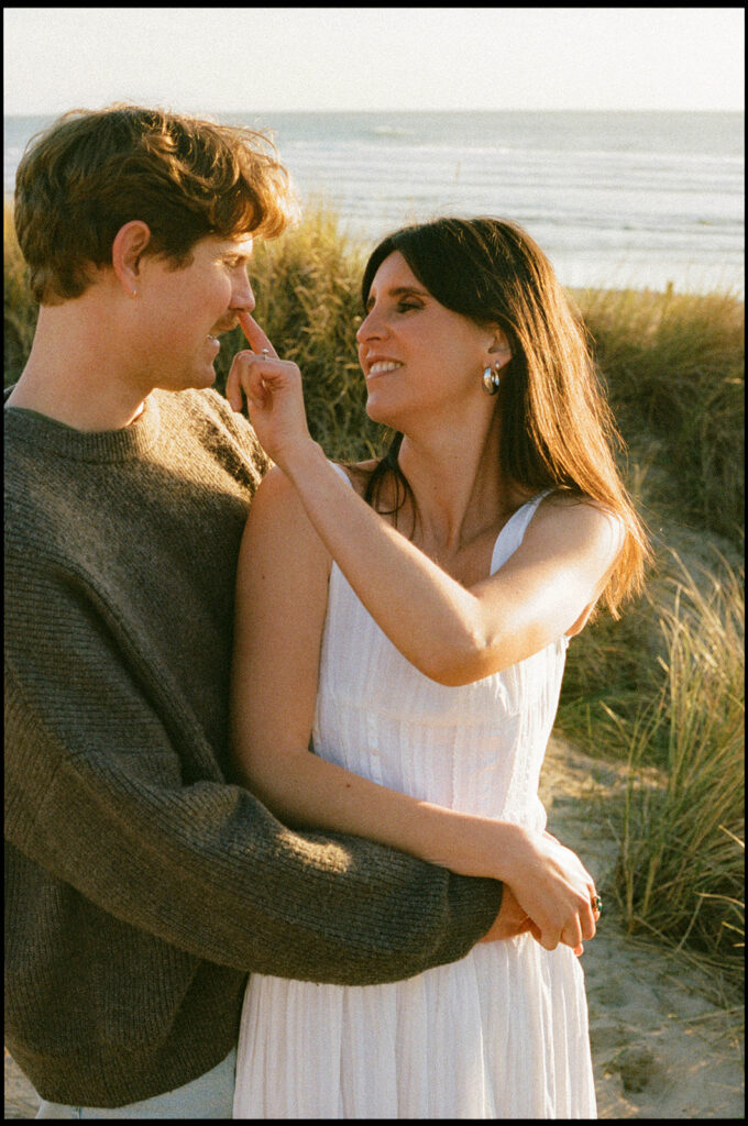 Woman playfully touching man’s nose