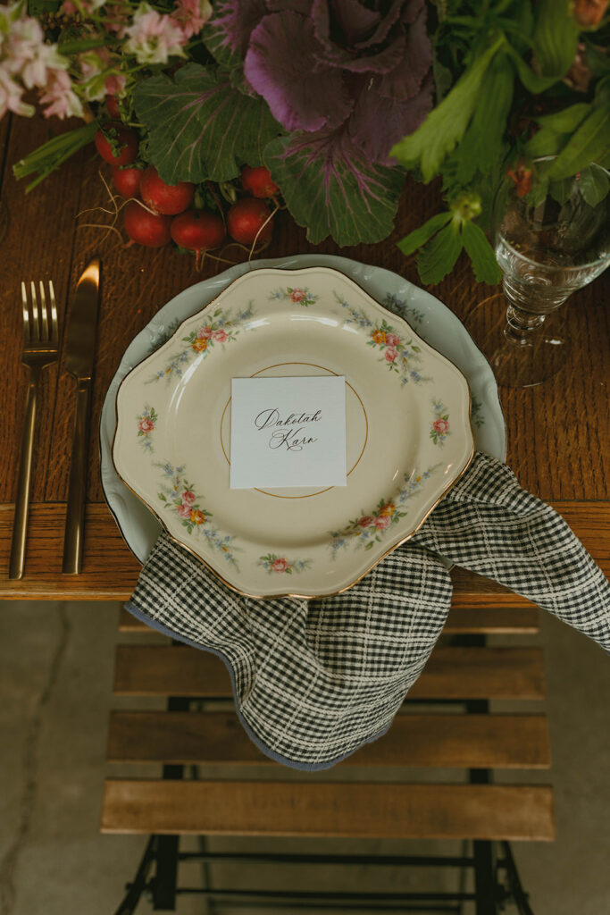 Close-up place setting with floral plate and menu card