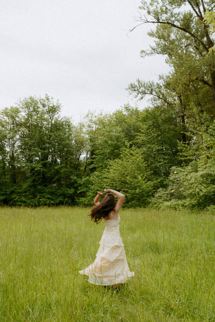 Senior twirling in meadow