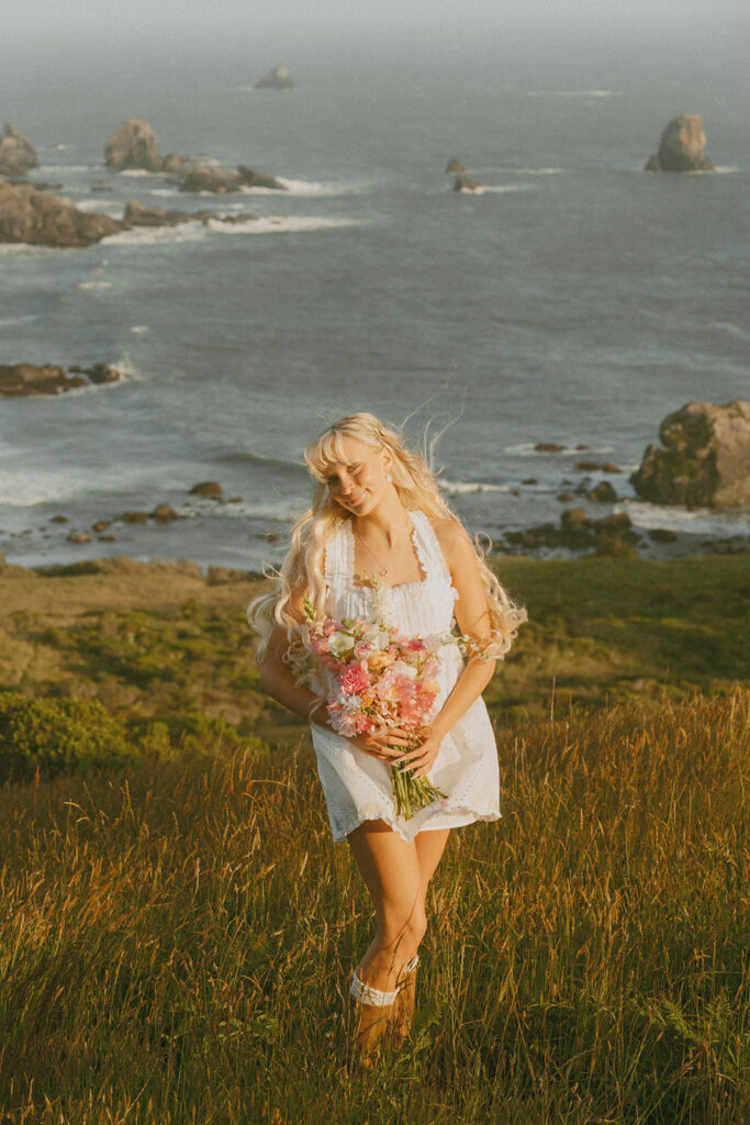 Senior holding a colorful bouquet by the coast