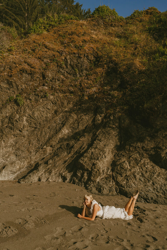 Senior lying on a rocky beach