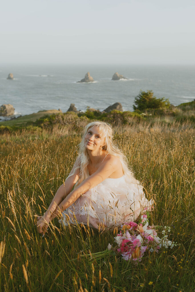 Senior sitting in tall grass with flowers