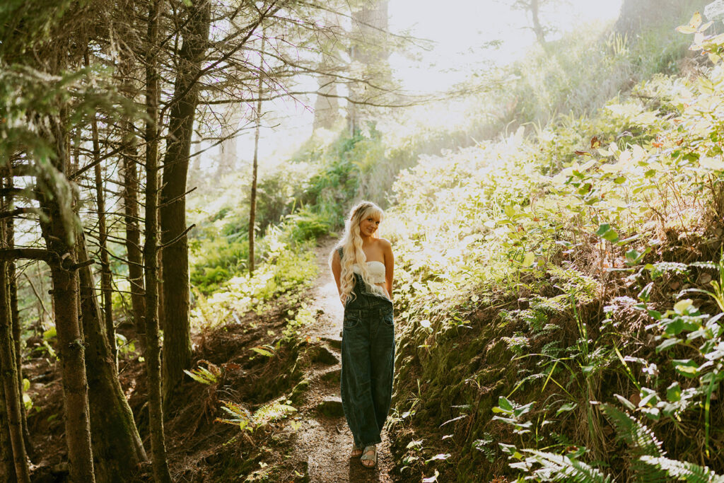 Senior walking through a sunlit forest trail