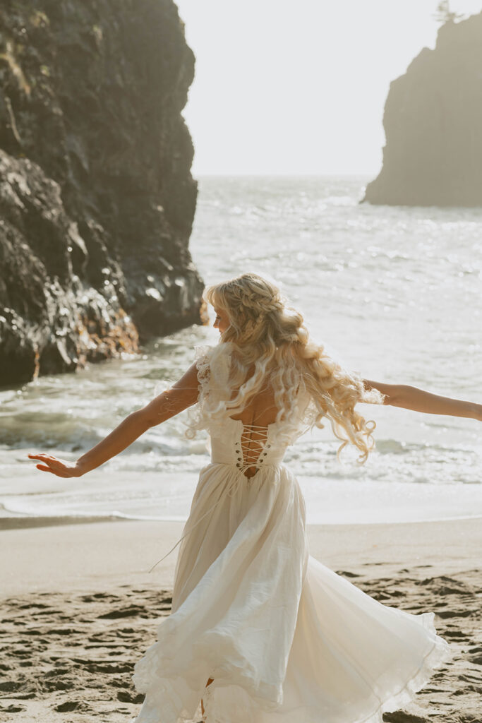 Senior twirling on a rocky beach
