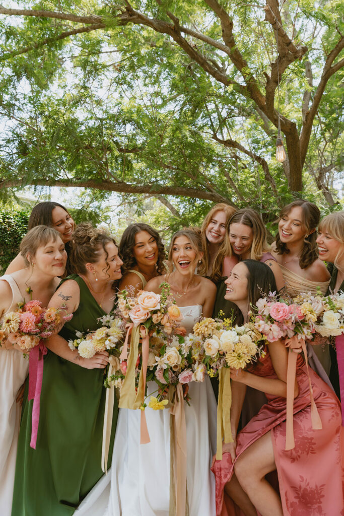 Group posing with colorful flower bouquets