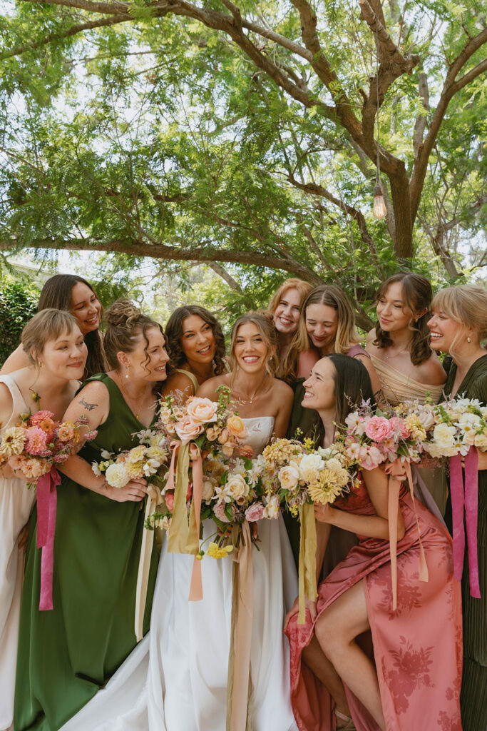 Group laughing together with floral bouquets
