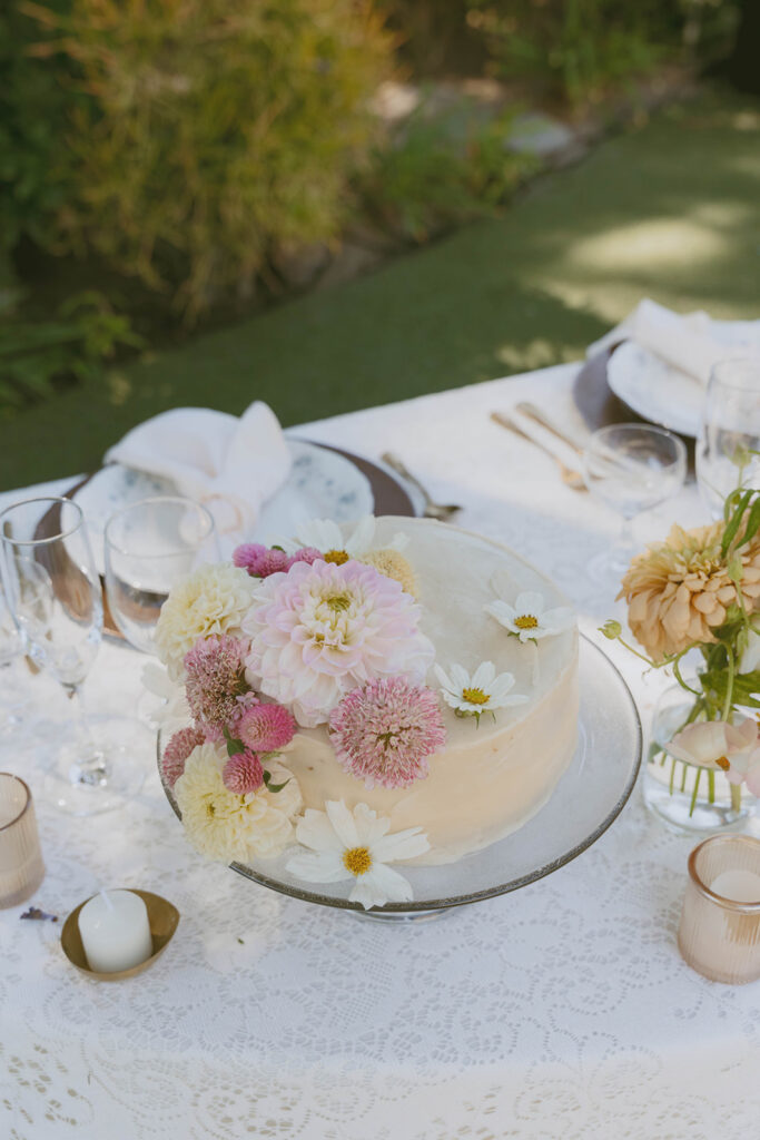White cake decorated with pastel flowers