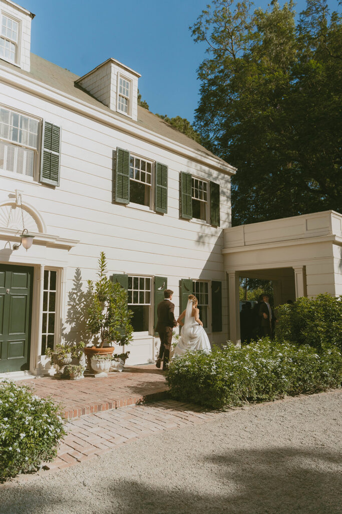 Couple walking toward a white house