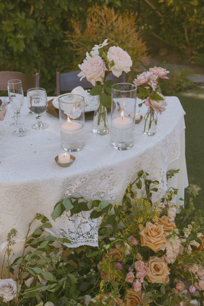 Lace table with candles and pink flowers